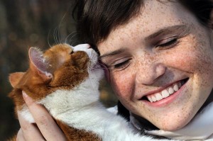 CatLickingFreckledGirl shutterstock_85160746